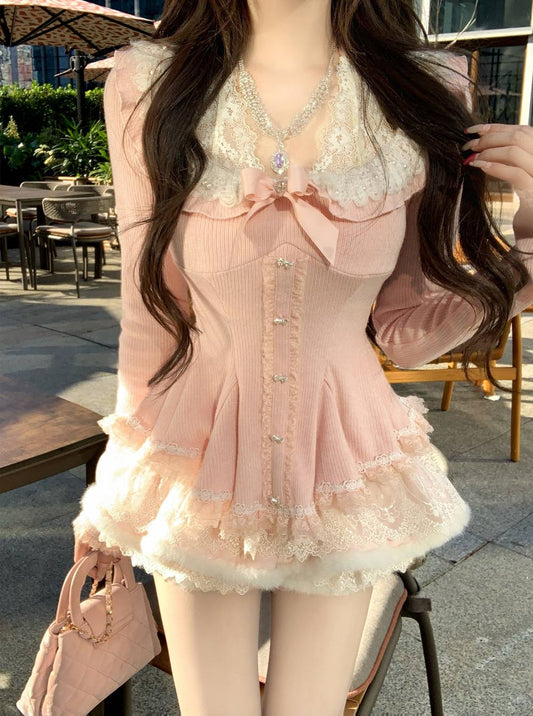 Person wearing a pink dress with lace details outdoors.
