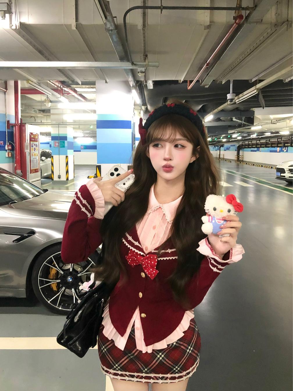 Person in a parking garage holding a plush toy and a handbag