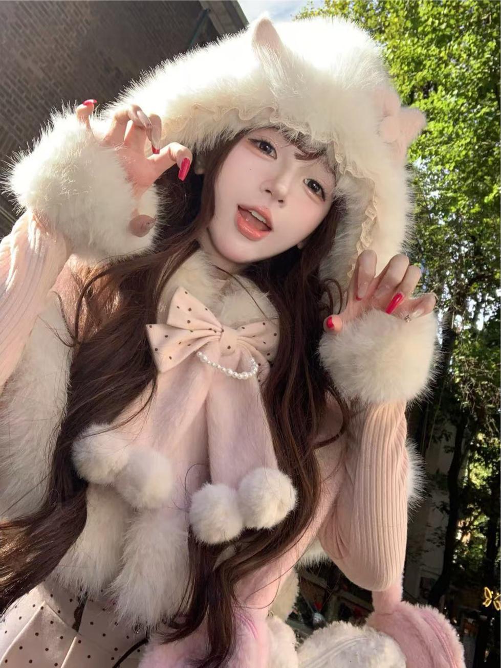 Person wearing a fluffy white hat and gloves with a pink outfit, outdoors.