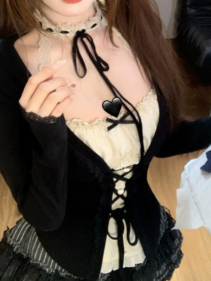 Person wearing a coquette black and white outfit with lace details.