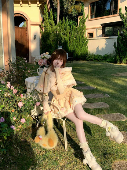 Person in a garden setting with flowers and a building in the background
