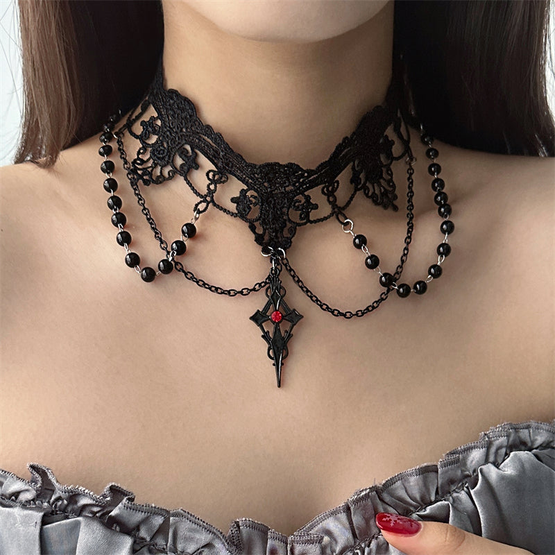 Black lace and bead necklace worn by a person with a blurred background