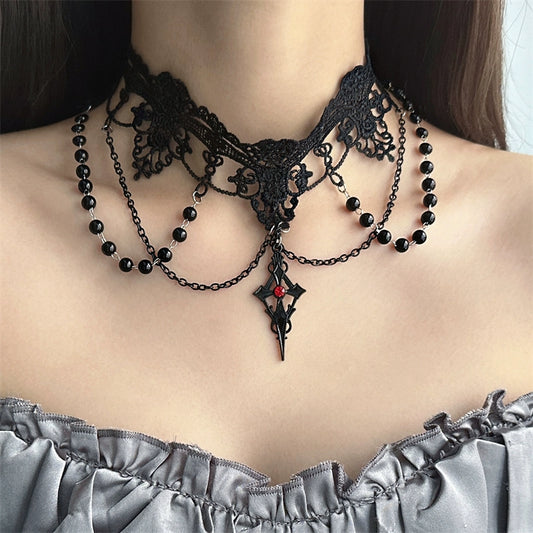 Black lace and beaded choker necklace on a person wearing a gray off-shoulder top.