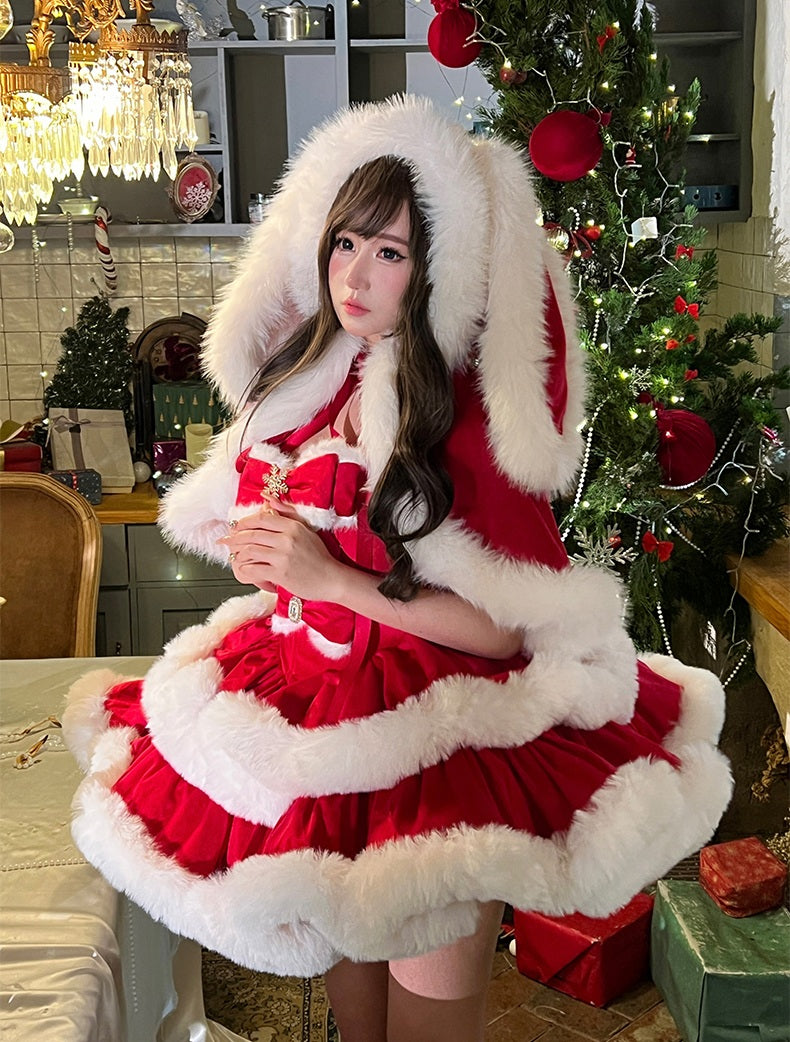 Person in a festive outfit with a Christmas tree and decorations in the background