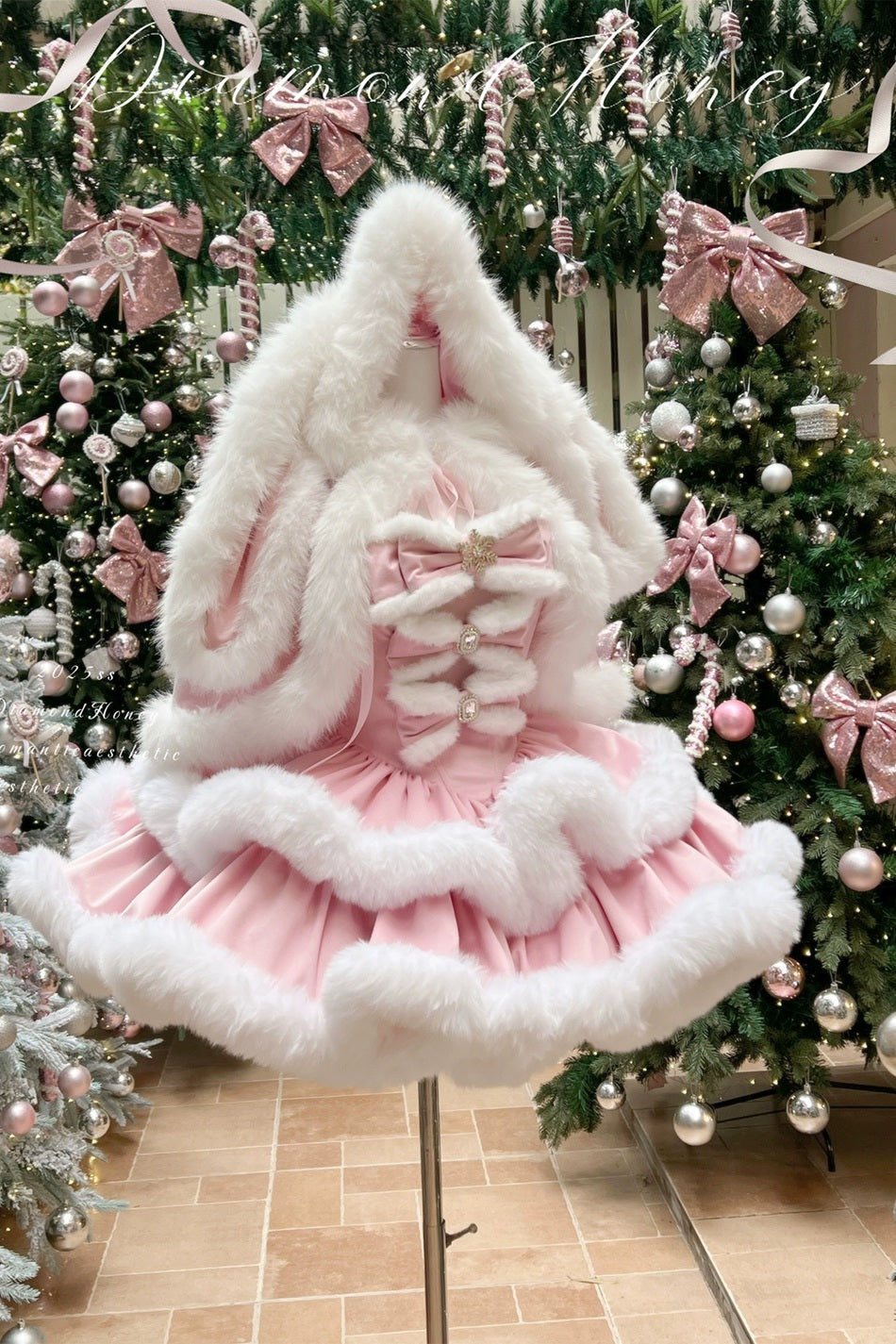 Decorative Christmas tree skirt with pink and white fur trim in front of a decorated Christmas tree.