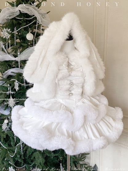 White fur coat with decorative buttons hanging on a Christmas tree,