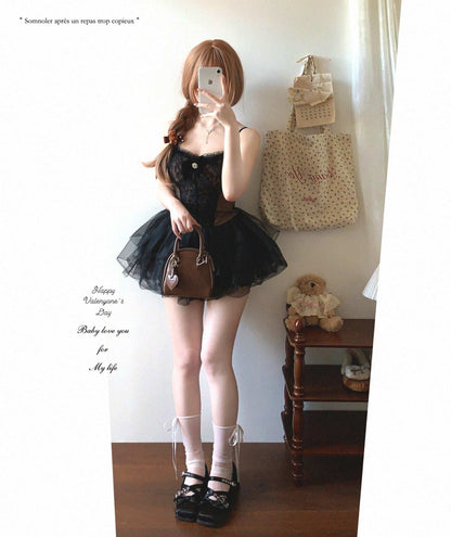 Person wearing a black dress with sheer overlay and white stockings, holding a brown handbag.