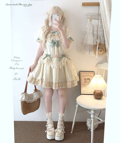 Person wearing a light-colored dress with ruffles and bows, standing in a room.