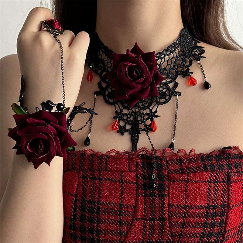 Person wearing a black lace choker with red roses and a red plaid dress.