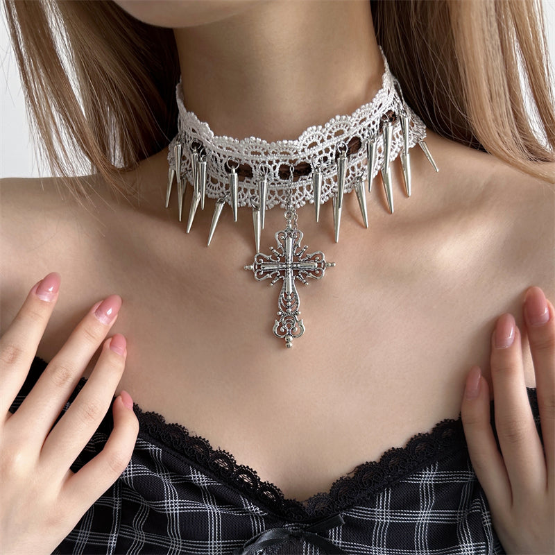 Close-up of a person wearing a gothic-style choker necklace with spikes and a cross pendant.