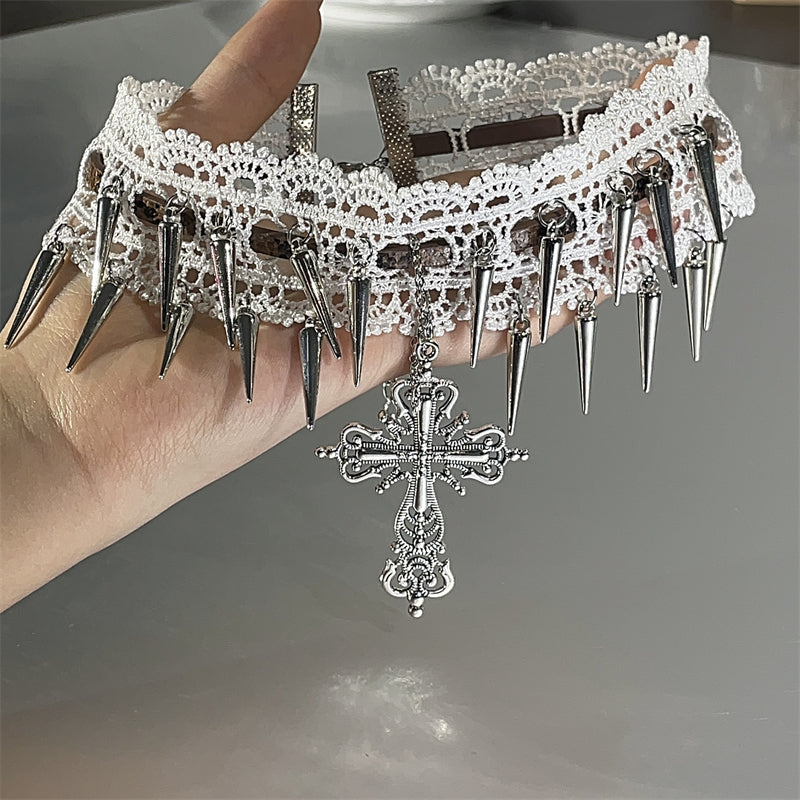 Decorative choker with spikes and a cross pendant on a neutral background