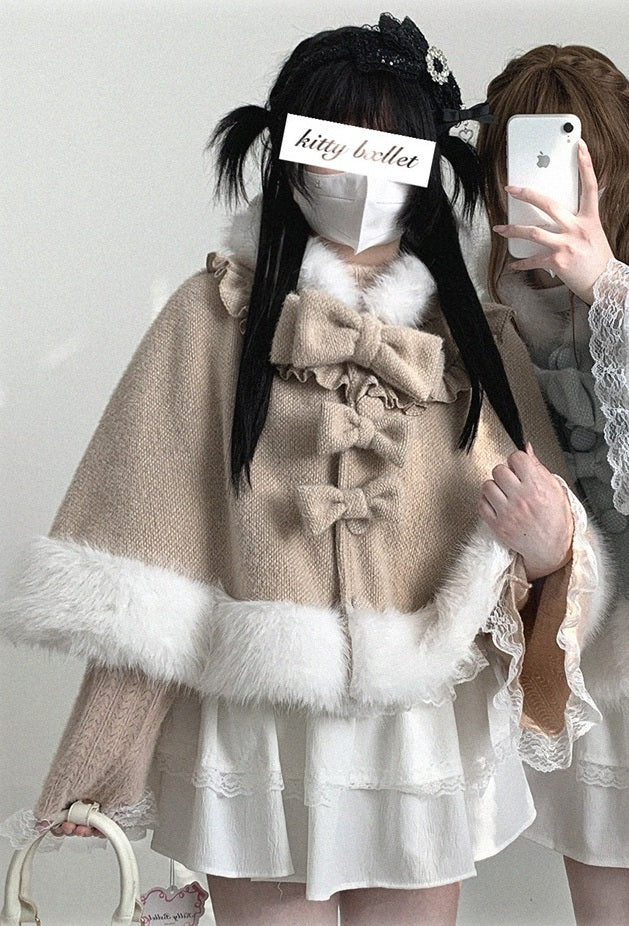 Person wearing a beige bow-detailed coat with white fur trim against a plain background