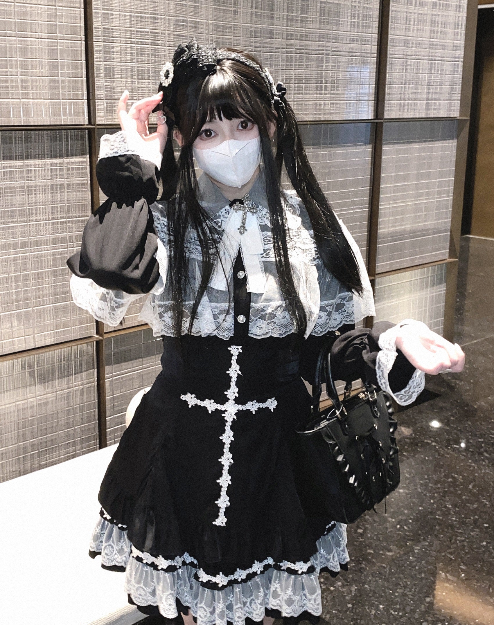 Black and white blouse top with lace details and bows.