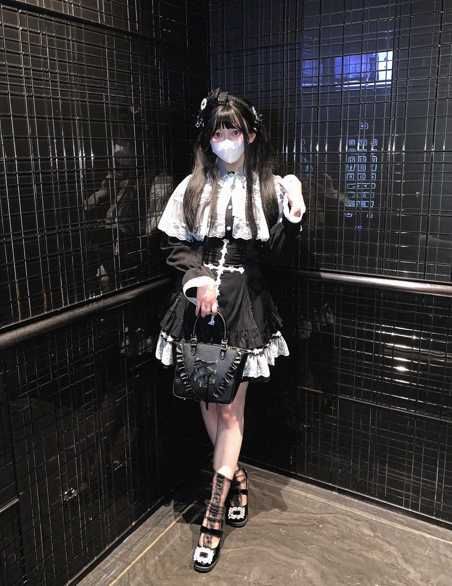 a woman wearing a white blouse and black high-waisted skirt with lace cross detailing and ruffle trim