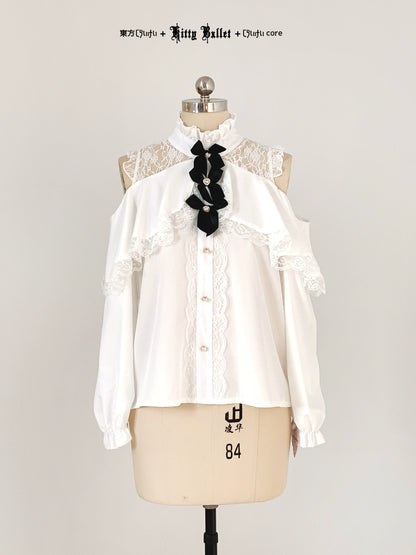 White blouse with black bow on a mannequin against a white background