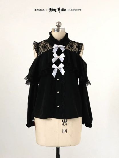 Black blouse with lace details and white bows on a mannequin against a white background