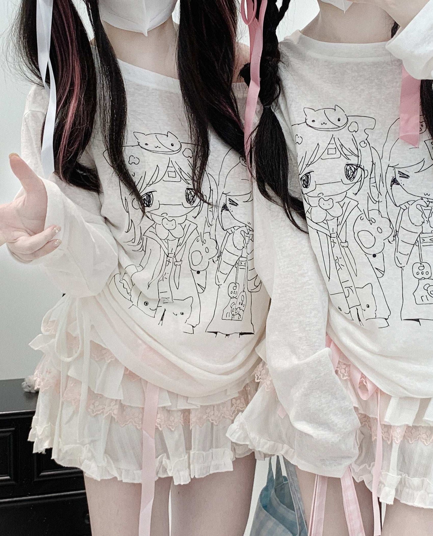 loose-fit sheer top with off-shoulder design and fun anime girl print