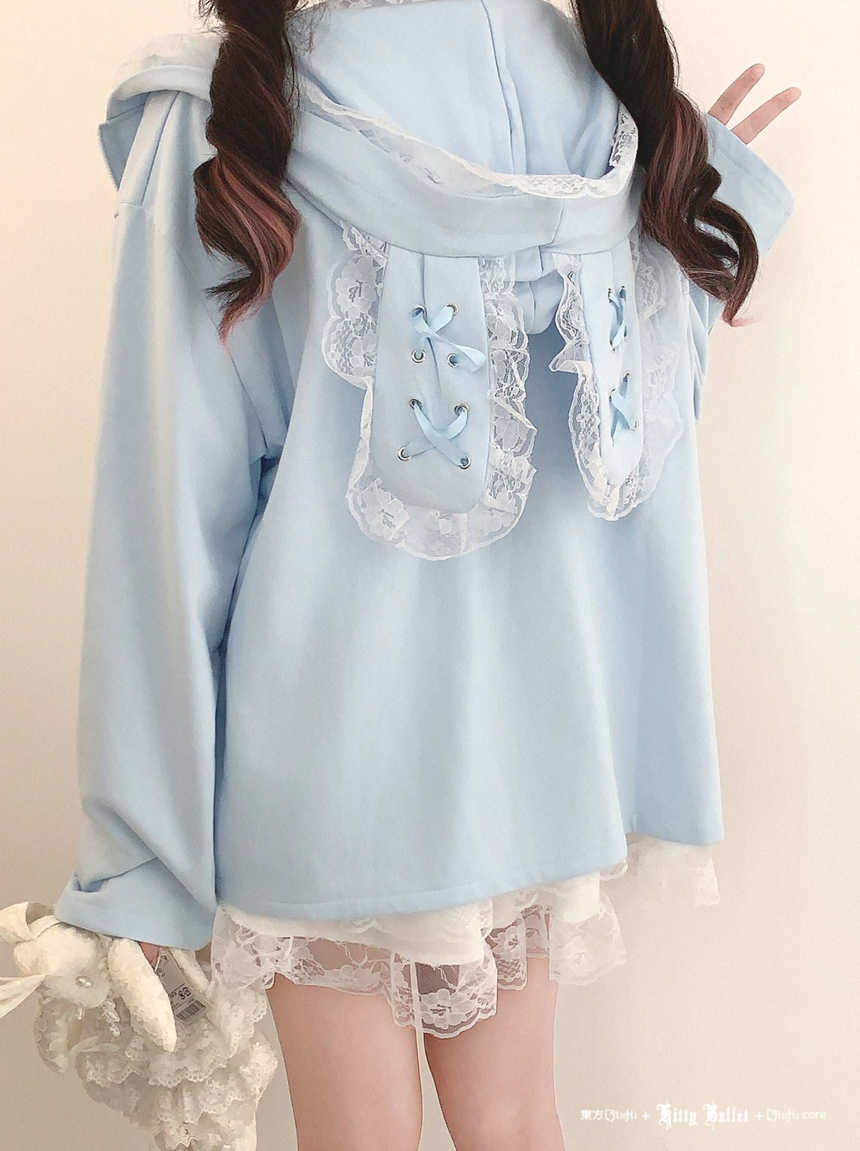 Light blue dress with lace details on a plain background