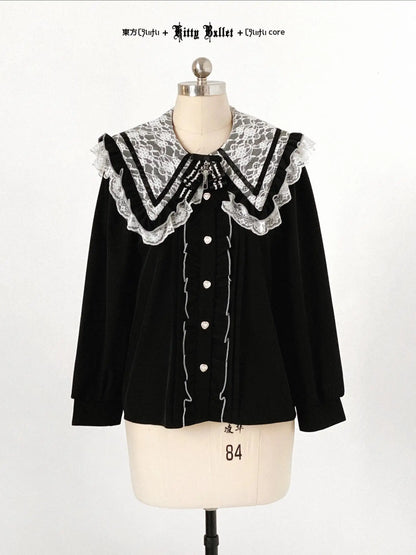 Black blouse with lace collar on a mannequin against a white background