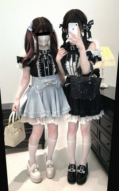 Two people in Jirai Kei fashion outfits standing in a room.