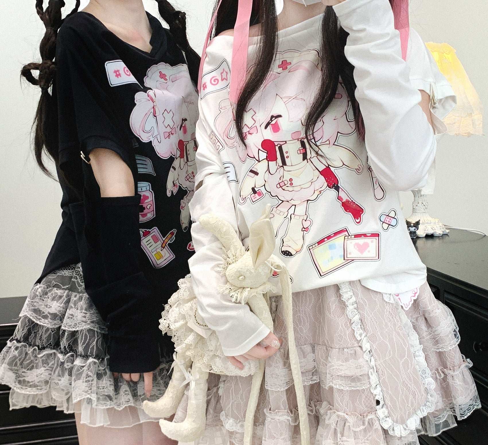 Two people wearing outfits with cartoon character designs and ruffled skirts.