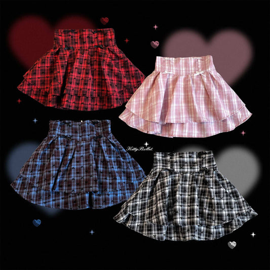 Four plaid skirts in different colors on a black background with heart shapes.
