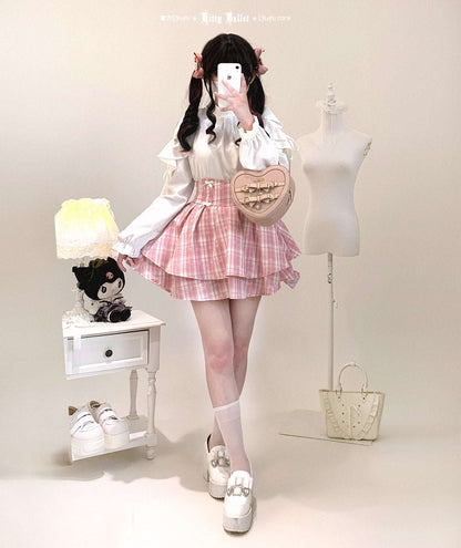 Person wearing a cute outfit with a white shirt, pink skirt, and white shoes in a studio setting.
