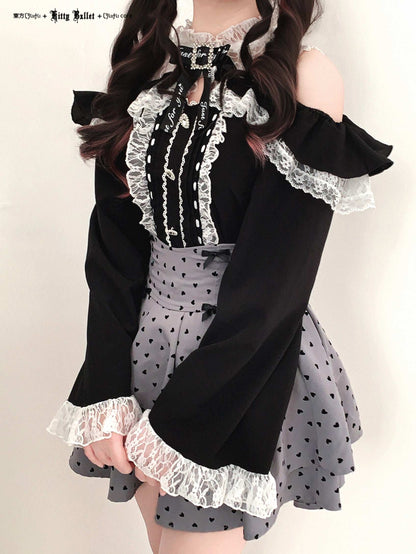 Black and white outfit with lace details in jirai kei style on a plain background