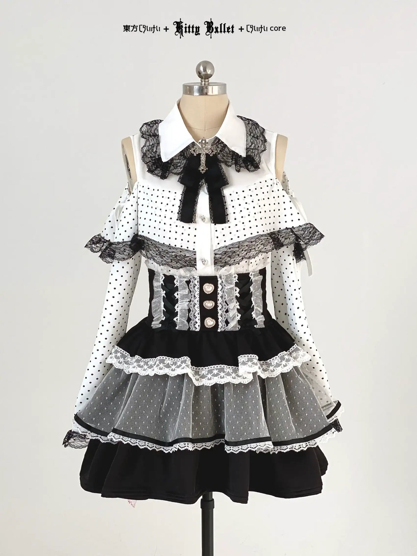 Black and white jirai kei polka dot dress with lace details on a mannequin against a plain background