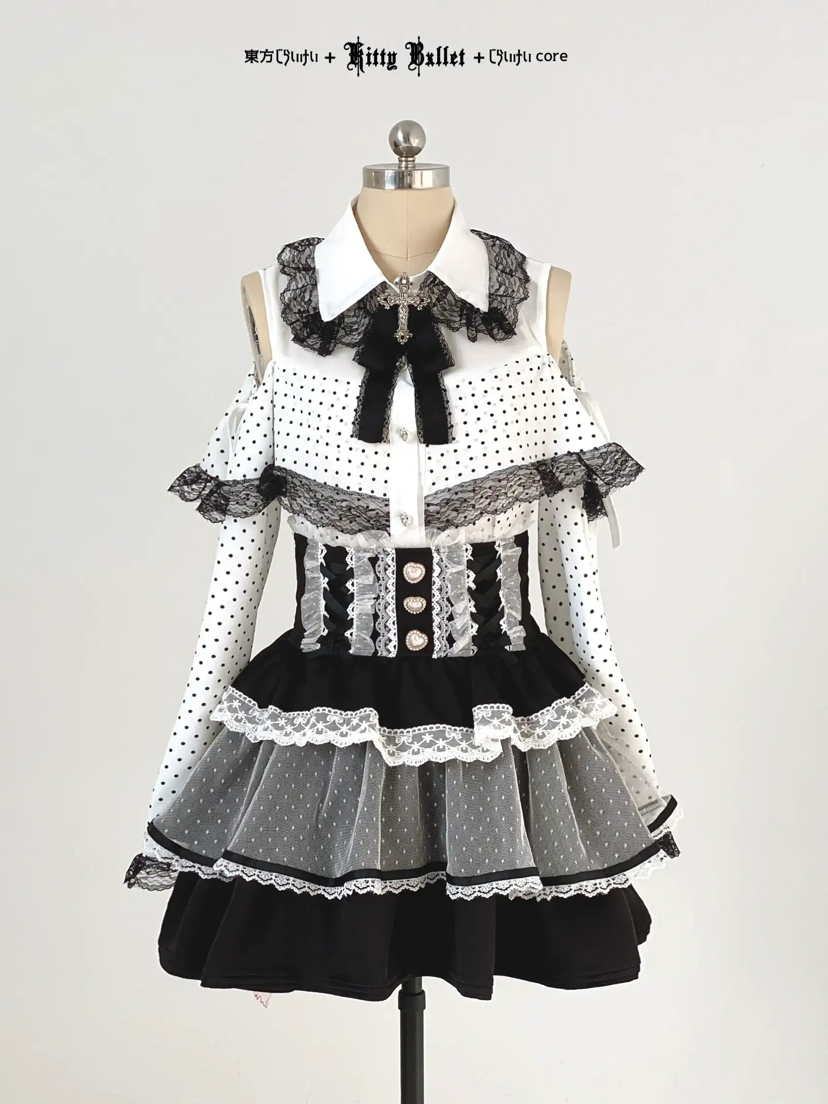 Black and white jirai kei polka dot dress with lace details on a mannequin against a plain background