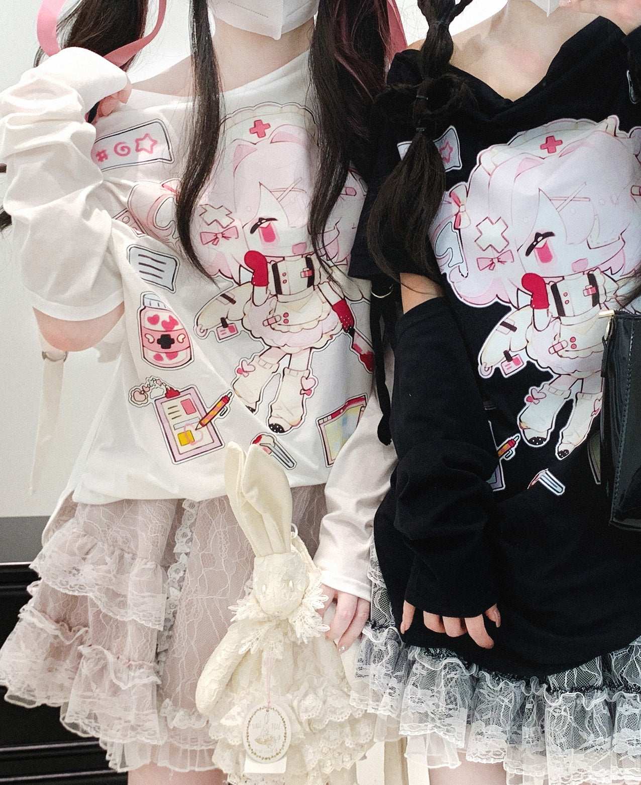 Two people wearing outfits with cartoon character designs and ruffled skirts.