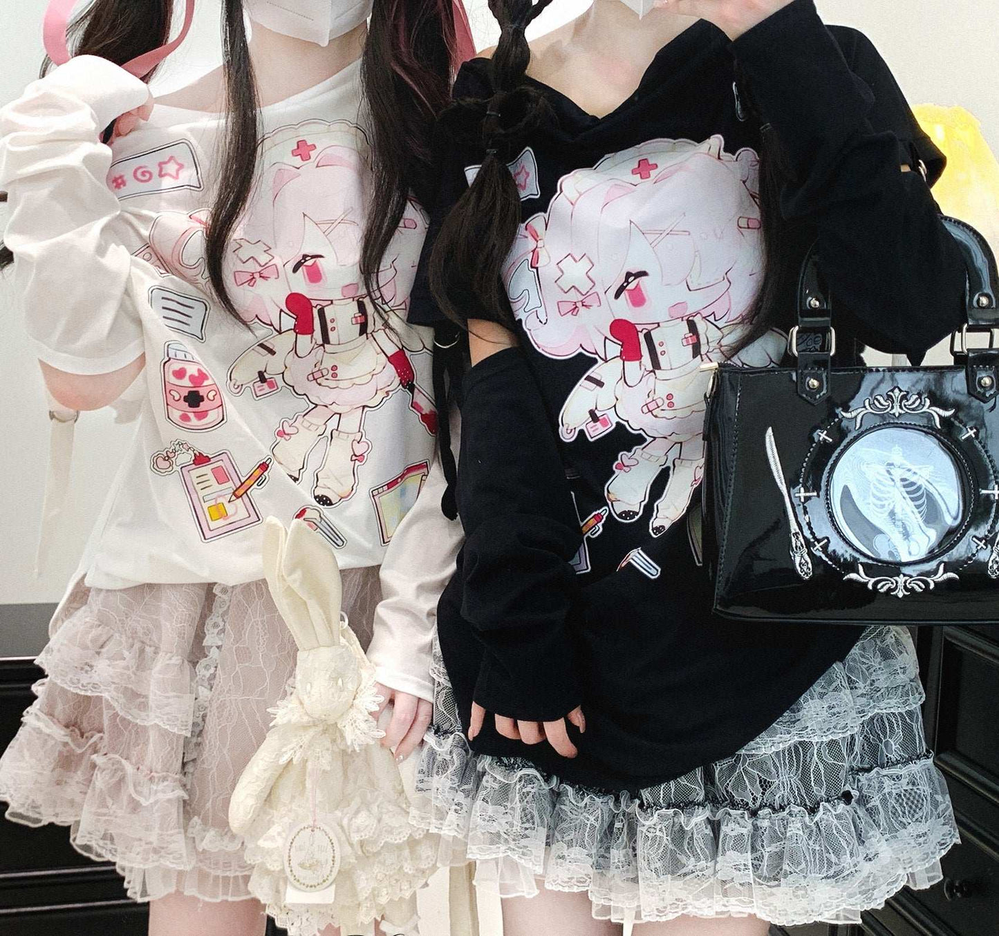 Two people wearing cute outfits with cartoon designs, one holding a black handbag.