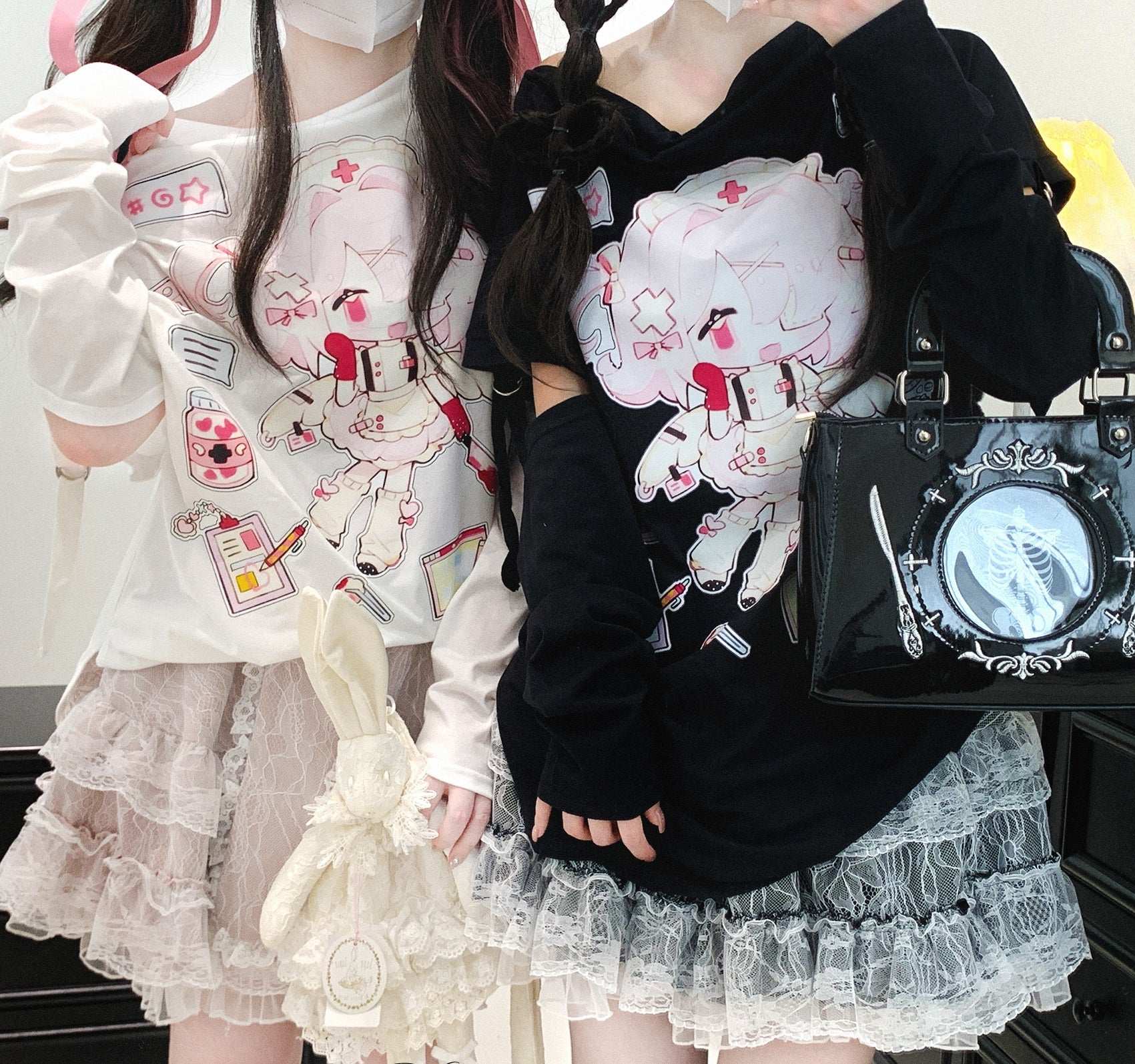 Two people wearing cute outfits with cartoon designs, one holding a black handbag.