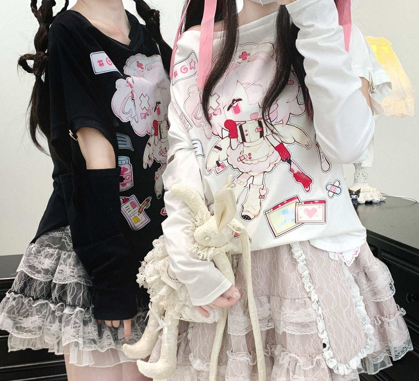 Two people wearing outfits with cartoon character designs and ruffled skirts.