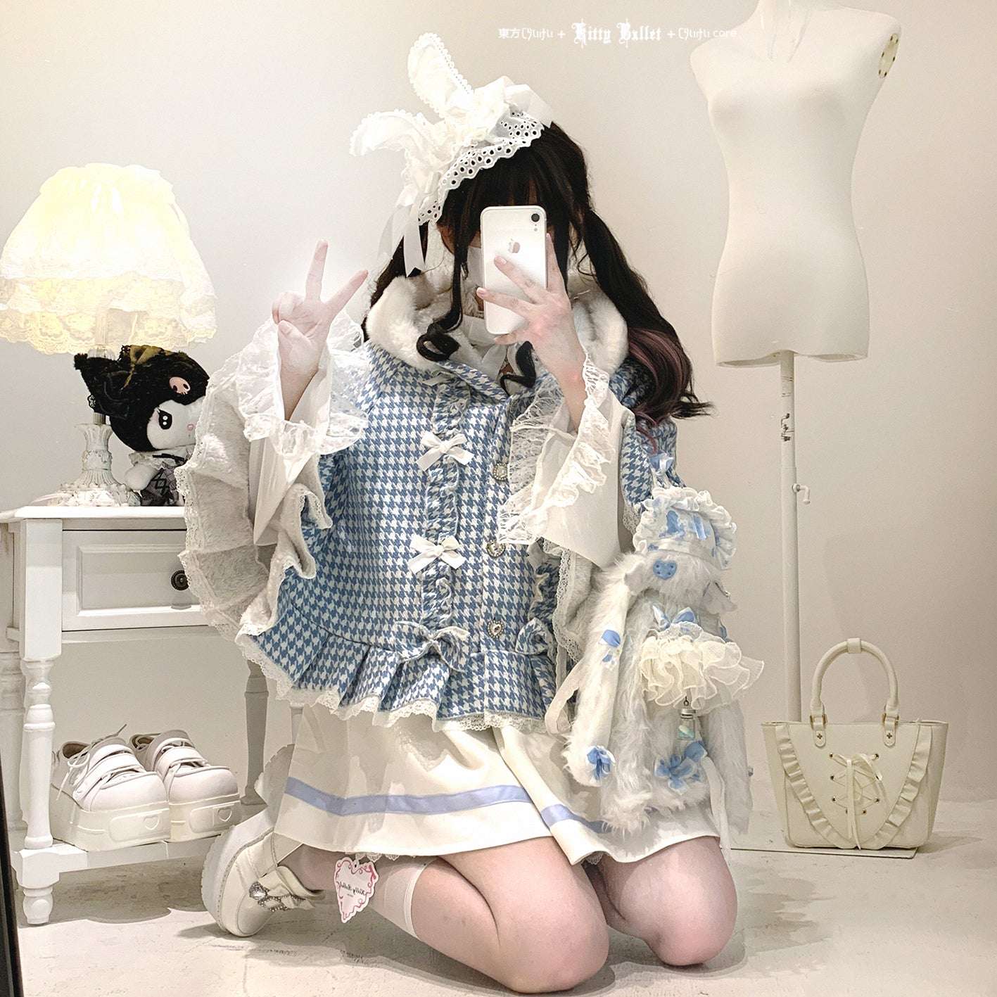 Person wearing a blue and white checkered dress with ruffles, kneeling on the floor.