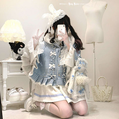 Person wearing a blue and white checkered dress with ruffles, kneeling on the floor.