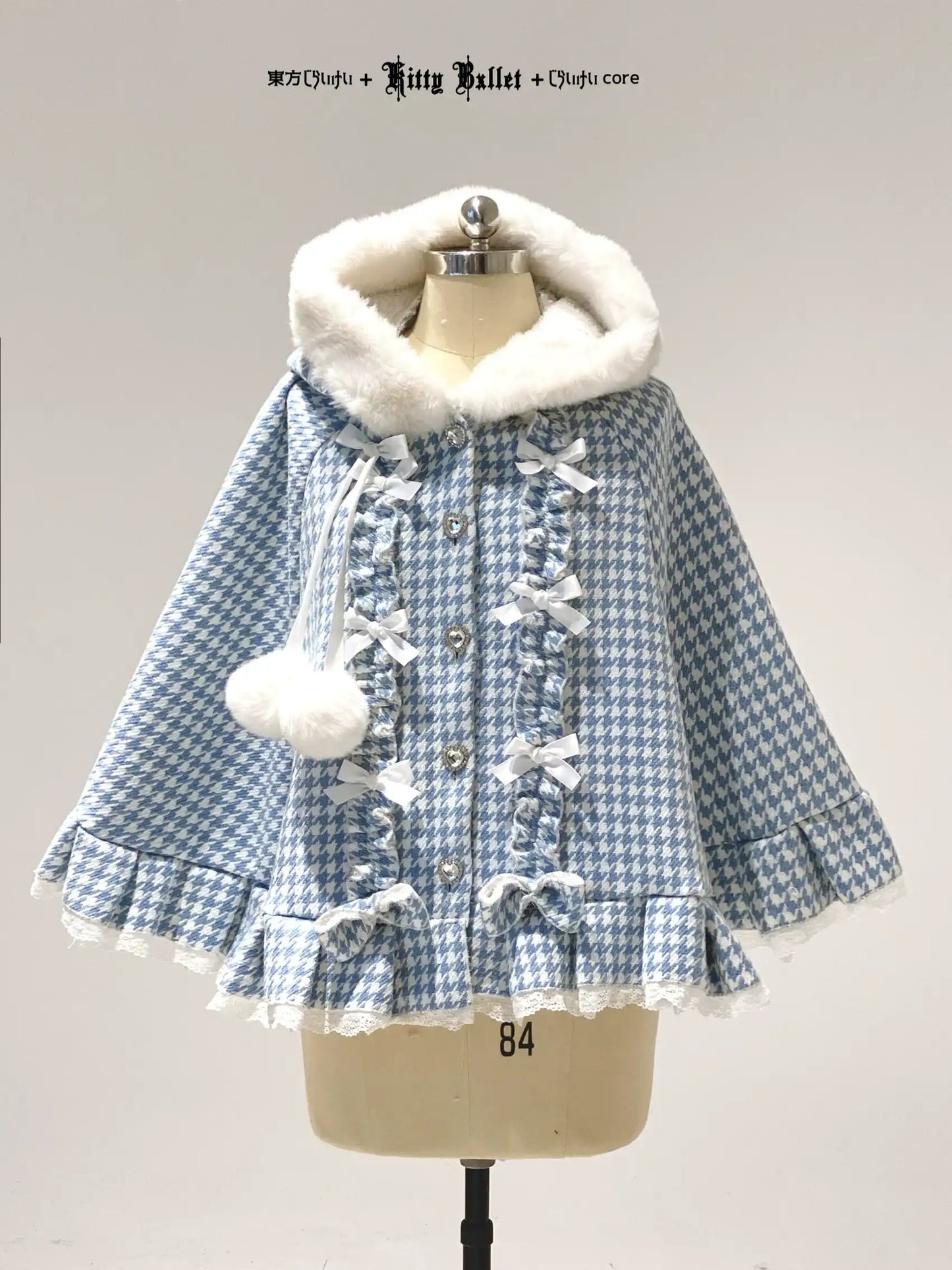 Blue and white checkered coat with white fur hood on a mannequin against a gray background