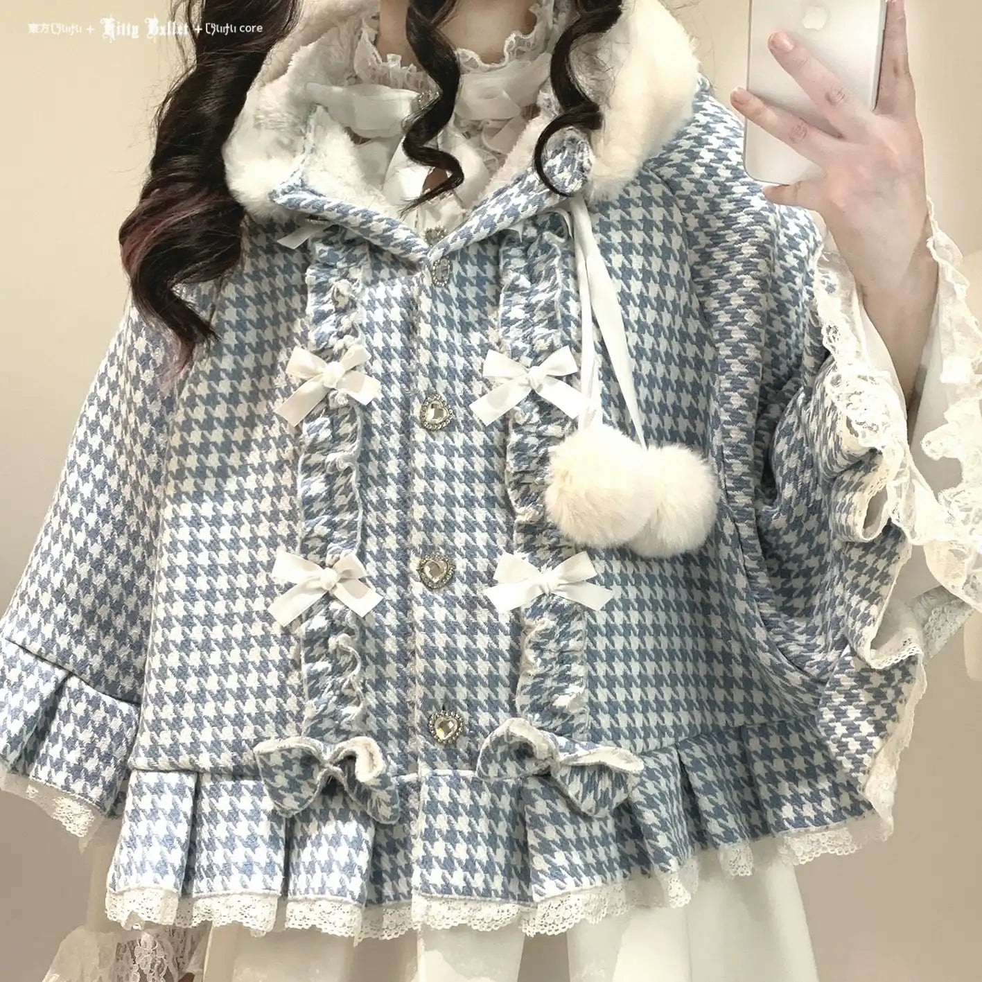 Blue and white checkered coat with decorative elements worn by a person.