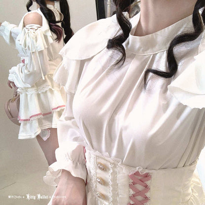 Person wearing a white dress with ruffles and lace details, standing in front of a mirror.