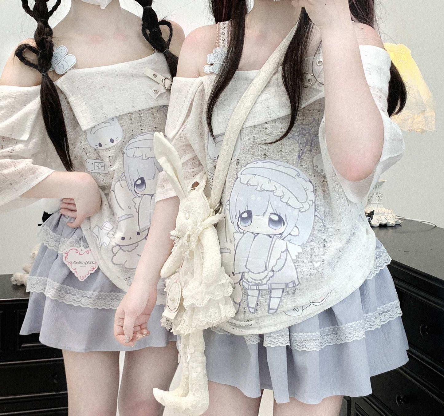 Two people wearing matching outfits with cartoon character designs and a white top.