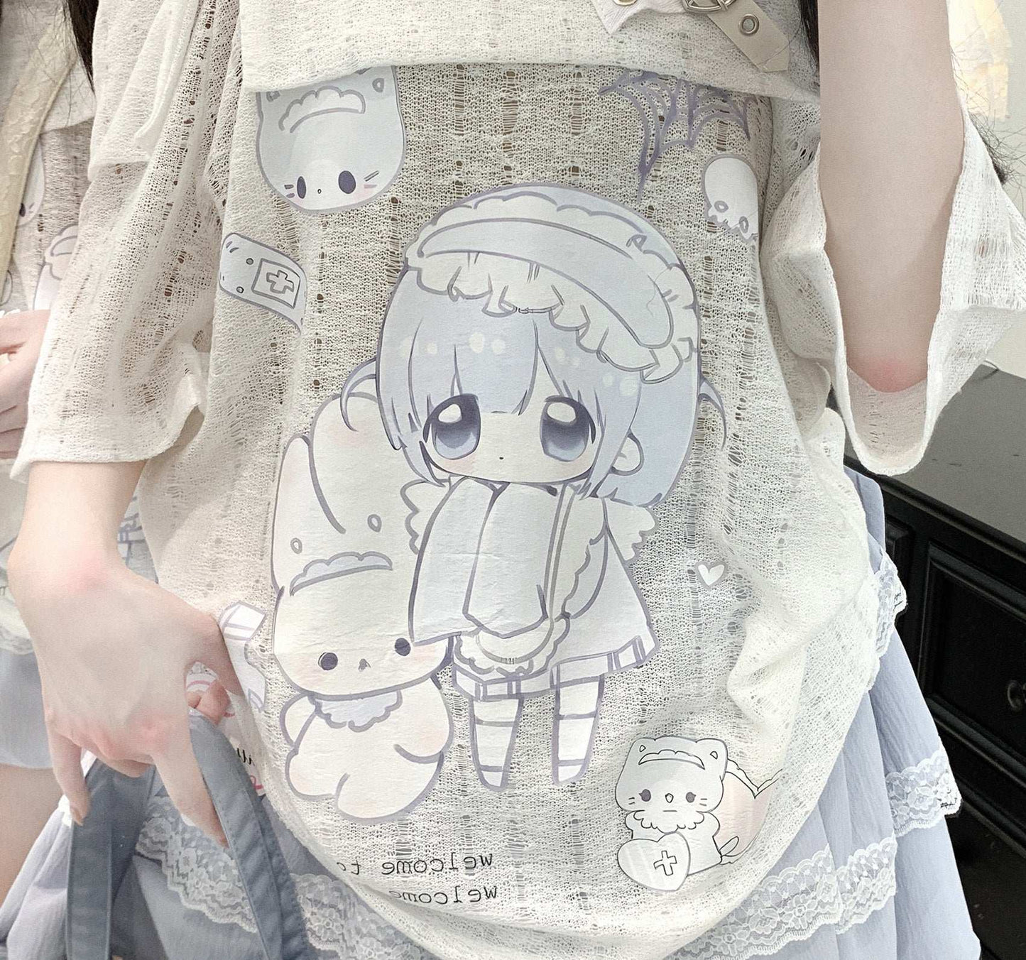 white off-the-shoulder top with beaded lace suspenders and anime girl print