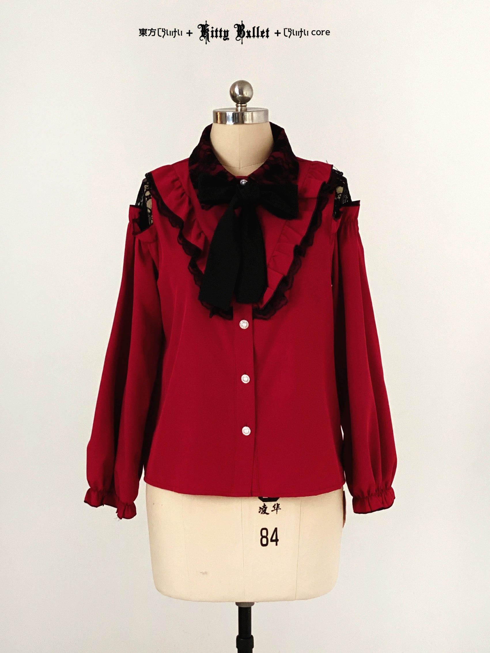 Red blouse with black lace details jirai kei style on a mannequin against a white background