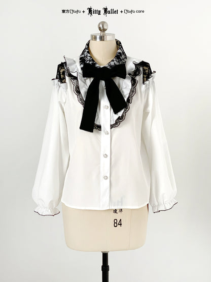White blouse jirai kei style with black lace and bow on a mannequin against a white background