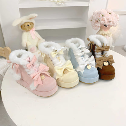 Set of pastel-colored children's boots with fluffy tops on a white surface.