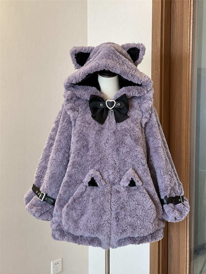 Purple plush coat with cat ears and a bow tie on a mannequin against a neutral wall.