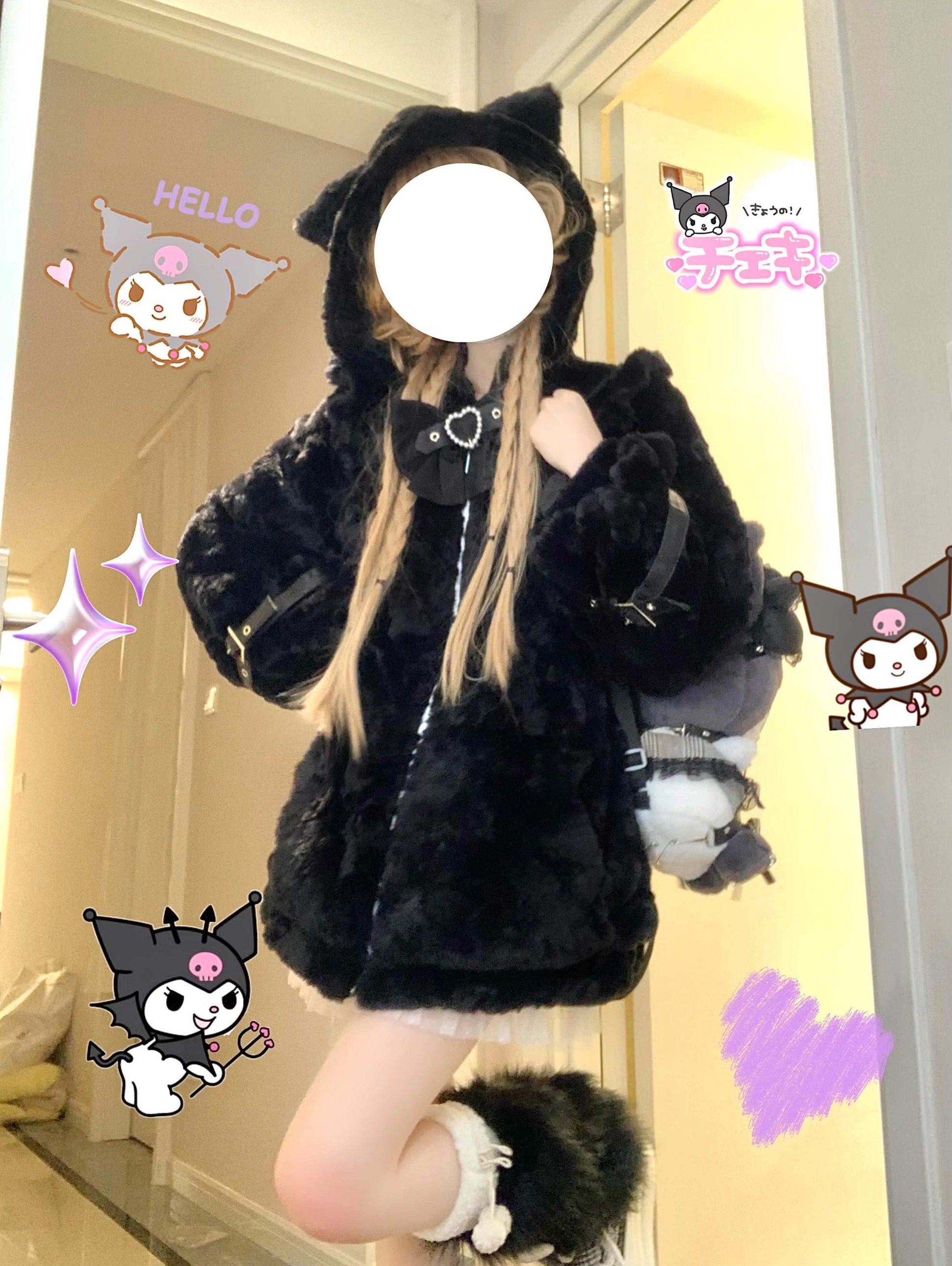 Person wearing a black fluffy coat with cartoon character stickers on a light-colored wall.