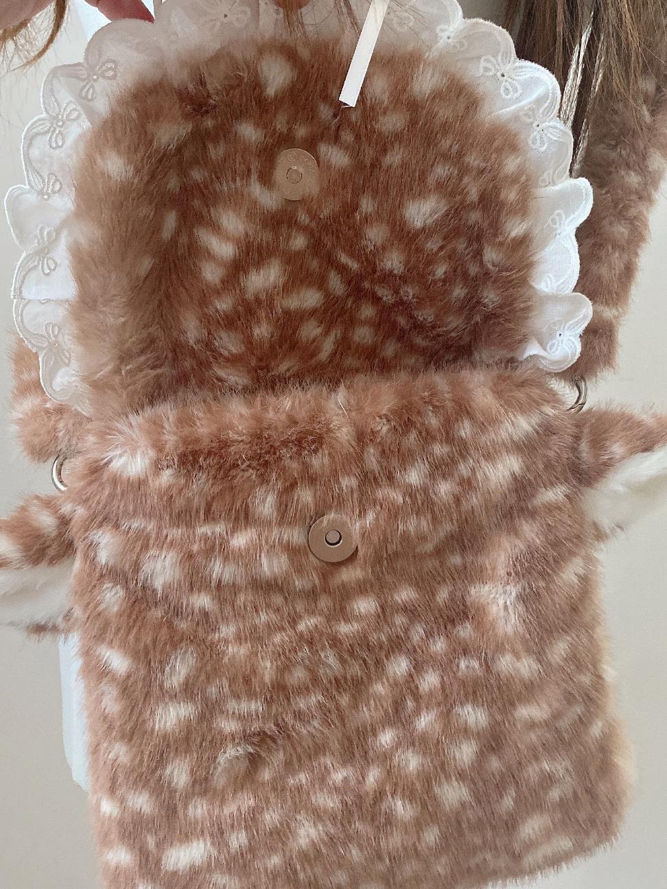 Brown and white patterned fabric with a button on a white background