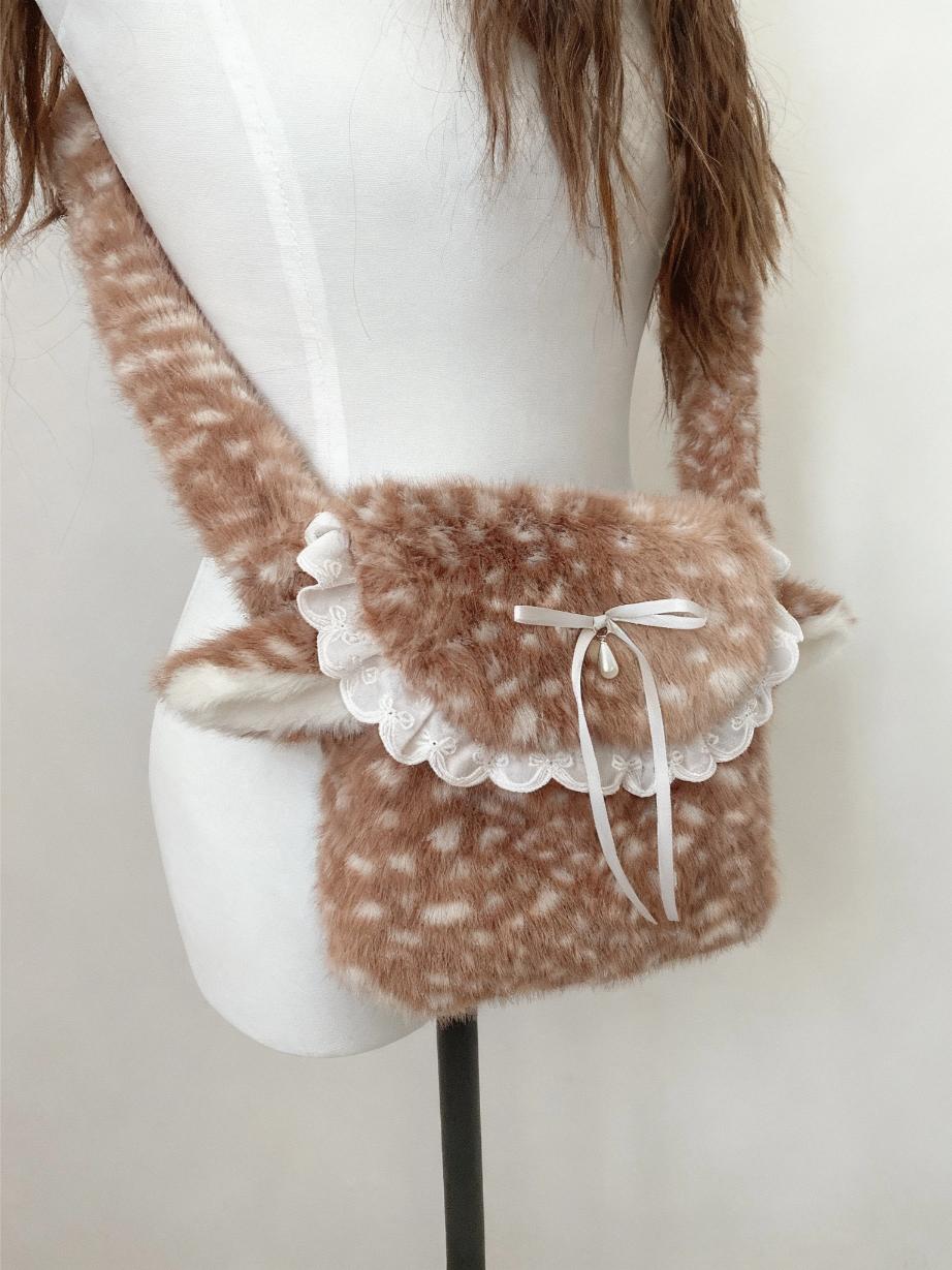 Fluffy brown bag with lace details on a mannequin against a white background