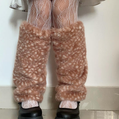 Brown fuzzy pants worn with white tights and black shoes on a plain background