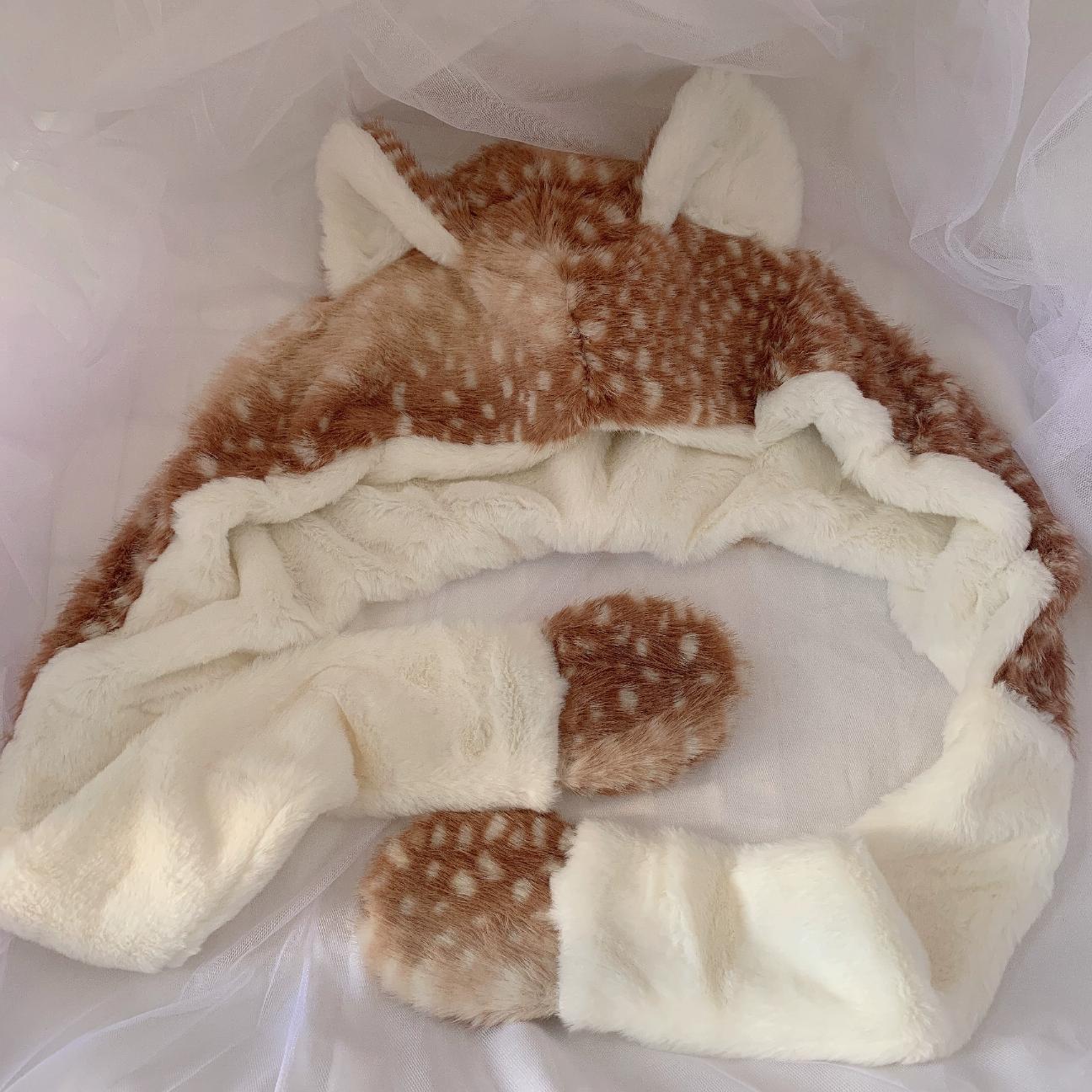 Fur-lined hat with deer antler design on a white background